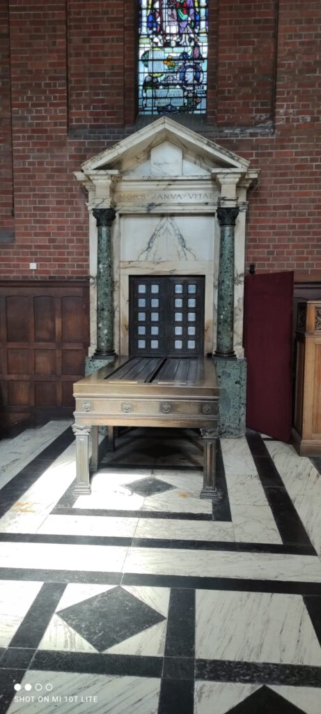 Hindu priest chanting Vedic mantras during cremation ceremony UK.