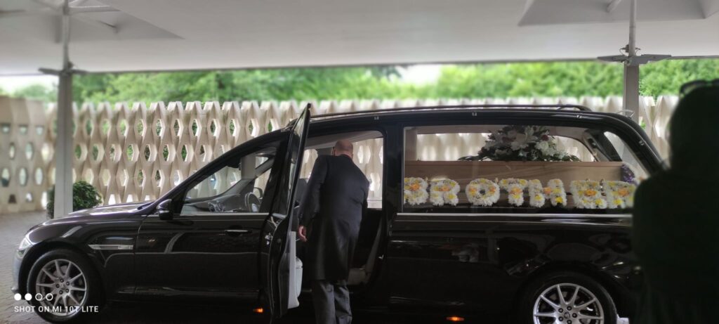 Hindu priest guiding family for ash immersion ritual after Hindu funeral.