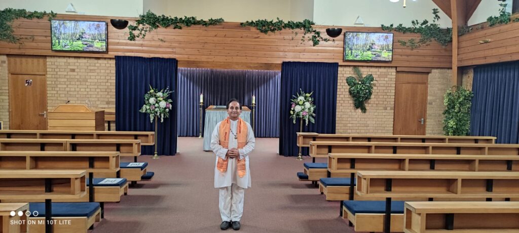 Family performing body purification rituals before the Hindu funeral in the UK.
