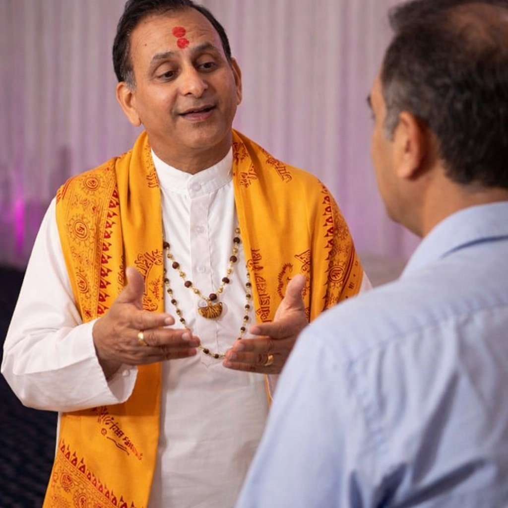Experienced Hindu priest UK in traditional attire ready to perform Hindu wedding ceremony abroad