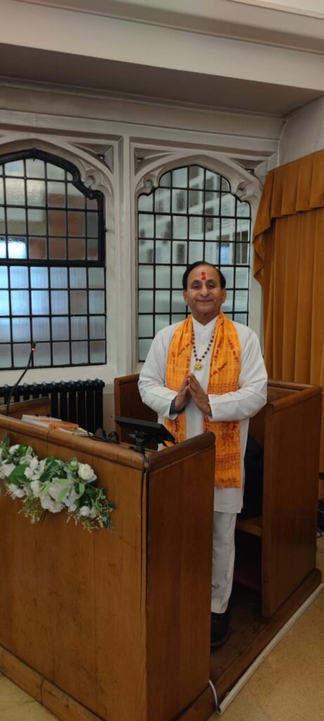 Indian priest chanting Hindu funeral mantras during cremation ceremony in the UK