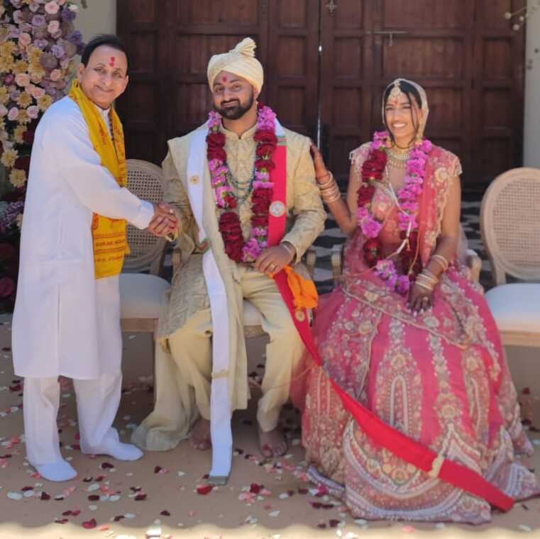 Indian wedding priest chanting Vedic mantras during Hindu wedding ceremony abroad