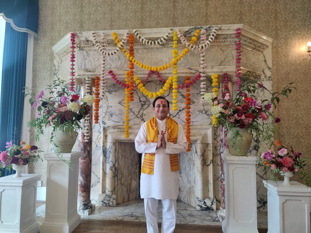 Hindu priest performing Hindu puja ceremony at a home in the UK